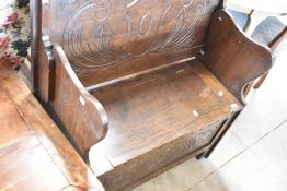 An early to mid 20th Century oak reproduction monks bench, width approx. 91cm