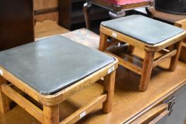 Two vintage footstools, having drop in tops