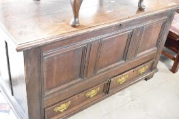 A 19th Century oak kist having drawer base with brass drop Georgian style handles, width approx.