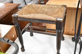 A 19th Century rush seated tool in the vernacular style with double stretcher design