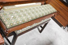 A 19th Century mahogany framed duet stool having woolwork seat and a tapestry footstool