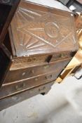 A period oak bureau having carved decoration including monogram to flap , VB, width approx. 95cm