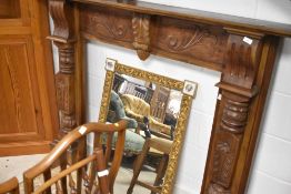 A reproduction carved fire surround and a 19th Century wall shelf