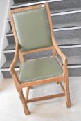 An Arts & Crafts Yorkshire golden oak arts and crafts carver chair, by Mouseman, having studded