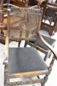 An early 20th Century oak framed carved chair having bergere cane back (af) and a matching dining