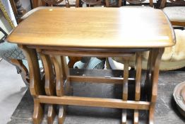 A modern nest of three tables, probably Ercol in a mid to dark stain, width approx. 56cm