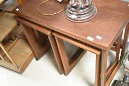 A vintage teak nest having fold out top, by Mcintosh
