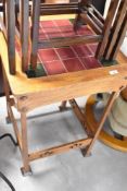 An Arts and Crafts style golden oak occasional/plant stand having tiled top, approx 51 x 51cm
