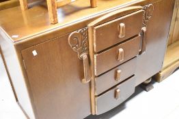 A mid 20th Century oak sideboard having four drawers to centre flanked by cupboards, width approx.