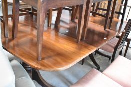 An interesting 19th Century twin pedestal dining table , having Regency supports, associated top