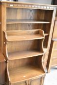 Two sets of Ercol bookshelves with cupboards under, including waterfall