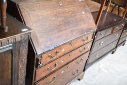 A Georgian oak bureau of nice proportions having fitted interior, drop flap and four long drawers,