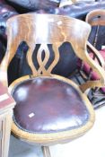 A vintage oak swivel office armchair