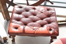 A modern buttoned leather footstool