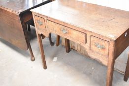 A period oak low boy in the 18th Century style , having shaped apron and square legs, width