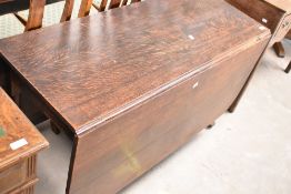 A 19th Century oak drop leaf table having shaped gateleg, approx width 118cm