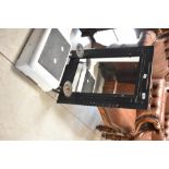 A reproduction cast iron framed mirror with candle sconces, width approx. 43cm