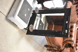 A reproduction cast iron framed mirror with candle sconces, width approx. 43cm