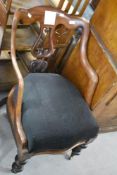 A Victorian mahogany dining chair having lute back, shaped arms and turned legs, with deep