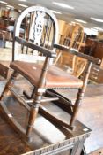 A vintage childs wheelback rocking chair