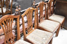 A set of four Georgian mahogany Hepplewhite style chairs having upholstered drop in seats