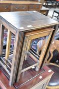 An early 20th Century oak nest of three tables