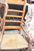 A 19th Century rush seated rocking chair having spindle back