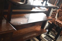 A Victorian mahogany buffet shelf, having three tiers, and scroll legs (af), width approx. 122cm