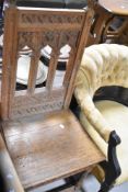 A traditional golden oak hall chair, in the Gothic style