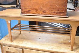 A vintage coffee table of stylised form having laminate top , width approx. 122cm