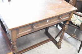 A mid 20th Century oak side table having frieze drawer and turned frame, width approx. 84cm