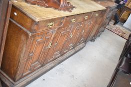 A Victorian oak sideboard having brass aesthetic style hand;es and cushioned style door fronts,