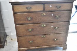 A Georgian oak chest of two short over three long drawers having brass handles and bracket feet,