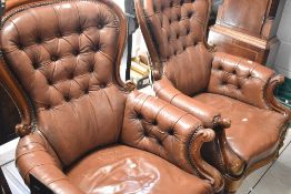 A pair of Victorian style mahogany framed armchairs having buttoned leather backs