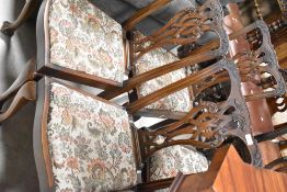 A set of four (three plus one) Chippendale revival style mahogany dining chairs having ball and claw