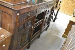 A late 19th or early 20th Century carved oak sideboard, width approx. 177cm