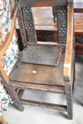 A period oak solid seat carver chair