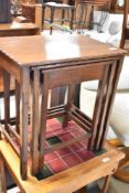 A nest of three mahogany tables having shaped edge and fine legs