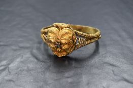 A Georgian yellow metal presumed gold hinged bracelet, the central pansy floral motif set with
