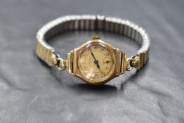 A 9ct gold cased Hirco wristwatch, the champagne dial having Arabic numerals and subsidiary dial,
