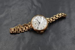 A 9ct gold cased Omega wristwatch, the white dial having Arabic numerals and subsidiary dial, the