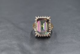 A 9ct gold mystic topaz ring having a large baguette cut mystic topaz within an illusionary border