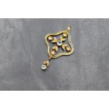 An Edwardian 9ct gold aquamarine and seed pearl set pendant, the central bezel set aquamarine in a