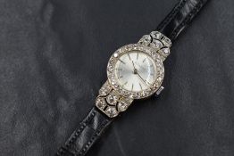 An Art Deco white metal Duward diamond set wristwatch, the circular silver tone dial having baton