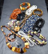 A selection of bead necklaces, bracelets and earrings including Baltic Amber, Tigers Eye, jet,