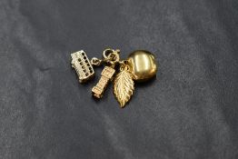 Three 9ct gold charms with ring clasps, in the form of double decker bus, Big Ben & an apple,