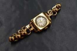 An 18ct gold Eldor wristwatch, the white dial having baton numerals in a square case, marked 18k &