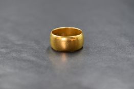 A 22ct gold band, of plain rounded form, marked 22, ring size H- I, 7.8g