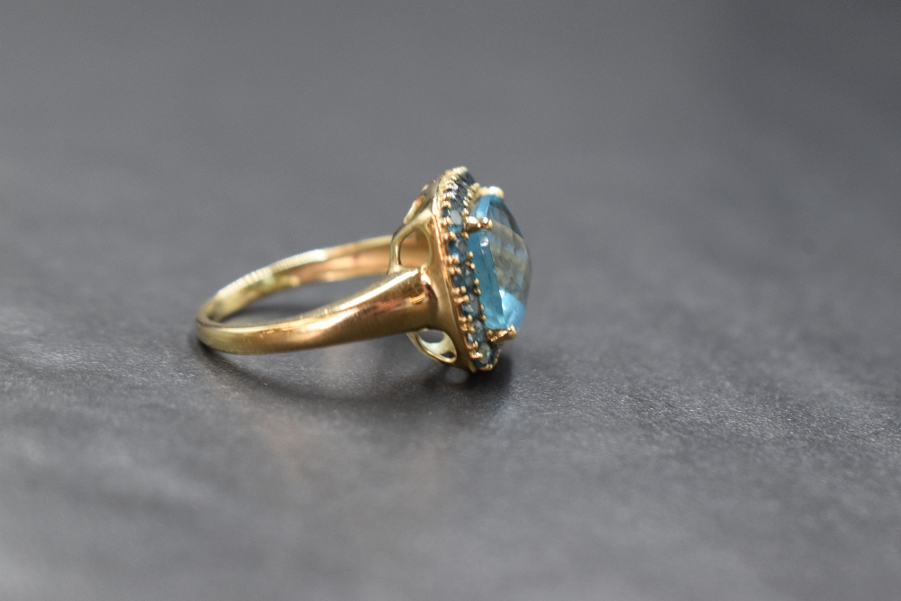 A 9ct gold blue topaz ring by QVC, the central cushion cut blue topaz within a halo surround of - Image 2 of 3