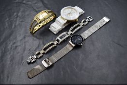 Four ladies fashion quartz wrist watches including Skagen, Fossil, Swarovski and Guess, non